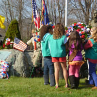 <p>A local Girl Scout troop lays a wreath Sunday at the Somers Veterans Memorial.</p>