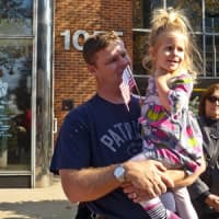 <p>Barry Hunt stands  with his two-year-old daughter Leana.watching the Stamford Veterans Day Parade go by</p>
