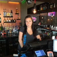 <p>Flipside Burgers and Bar Manager Lindsay Oakes poses behind the bar.</p>