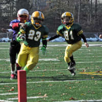 <p>Norwalk&#x27;s Nemo Harris turns the corner with help from Dean Tsiranides to score for the Packers.</p>