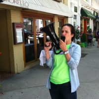 <p>Ann Spallone, district manager for Shoes &#x27;N&#x27; More, uses a megaphone to attract customers during the sidewalk sales on Friday.</p>