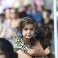 <p>A young girl wears headphones to protect her ears at Thursday&#x27;s concert.</p>