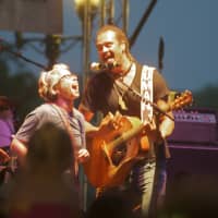 <p>A fan gets to sing on stage with Michael Franti.</p>
