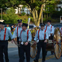 <p>An antique firefighting apparatus makes an appearances in Mount Kisco&#x27;s firefighters parade.</p>