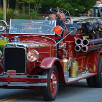 <p>A Bedford Hills vintage firetruck is driven in the Mount Kisco parade.</p>
