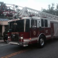 <p>A Turn of River (Stamford) firetruck is driven in the Mount Kisco parade.</p>