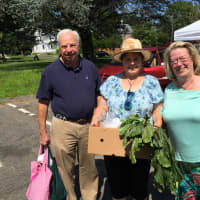 <p>Shoppers Priscillia and John Woyke join Market Master Lexi Gazy for a picture at the New Canaan Farmers Market on Saturday.</p>