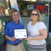 <p>Daily Voice managing Editor Joe Lombardi (center) presents Brian and Deb Hopkins with the DVlicious Best Ice Cream in Westchester award.</p>