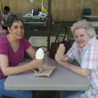 <p>Chris Roche (L) and Florence DiSano, of Somers, enjoy a cold ice cream on a hot day at King Kone.</p>
