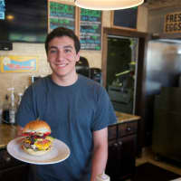 <p>Ian Mullen gets ready to serve the ever-popular Nacho Burger.</p>