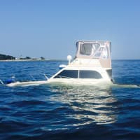 <p>The boat remains partially submerged in Long Island Sound off Norwalk.</p>