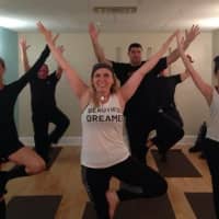 <p>Lieutenant Peggy Belles leads her colleages in the Tuckahoe Police Department in a yoga class. </p>