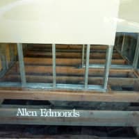 <p>A front window display area inside Allen Edmonds is stripped down to beams after Hurricane Sandy.</p>