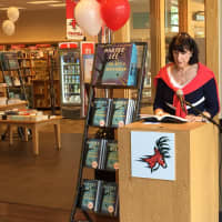 <p>Beverly Balaz, president of the Fairfield Chamber of Commerce, reads &quot;Go Set a Watchman&quot; during a live reading at the Fairfield University Bookstore Tuesday. </p>