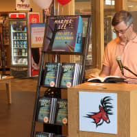 <p>Fairfield Director of Community &amp; Economic Development Mark Barnhart reads &quot;Go Set a Watchman&quot; during a live reading at the Fairfield University Bookstore Tuesday. </p>