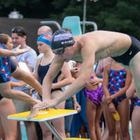 <p>A Katonah Swim and Dive club member takes to the water on July 9 in Katonah against Mount Kisco.</p>