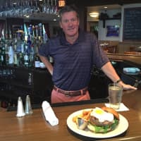 <p>Bogey&#x27;s Grille &amp; Tap Room Co-Owner Jim Stablein with a Prime Beef Burger.</p>