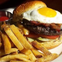 <p>The Prime Beef Burger, featuring Allen Brothers USDA prime blend, applewood smoked bacon, blue cheese and a fried egg.</p>