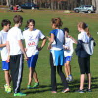 <p>Wilton Running Club coach Mary Zengo talks with runners before the start of the race.</p>