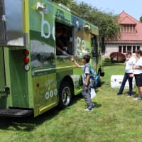 <p>Customers of all ages order food from the Bodega Taco Truck on the Great Lawn of Pequot Library during the 2014 Summer Book Sale.</p>