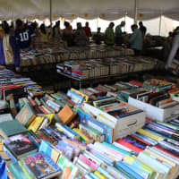 <p>Book lovers comb through the selection of books at last year&#x27;s sale.</p>