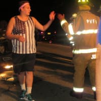 <p>One of the teenagers at the crash scene gives a high-five to a Putnam Valley firefighter.</p>