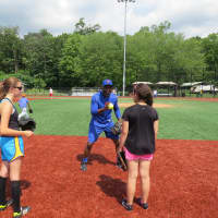 <p>Mookie Wilson explaining proper fielding techniques to A-Game Sports campers in New Rochelle.</p>