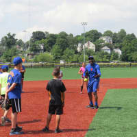 <p>Mookie Wilson explaining proper fielding techniques to A-Game Sports campers in New Rochelle.</p>