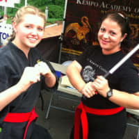 <p>Senseis Shannon Davis, left, and Erika Grieco strike a pose, at the Kempo Academy of Martial Arts tent at the Wilton sidewalk sale event Saturday.</p>