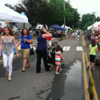 <p>People enjoyed walking on River Road during the sidewalk sale in Wilton.</p>