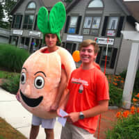<p>Someone&#x27;s gotta do it: On a warm, muggy morning these two young men are promoting Peachwave frozen yogurt.</p>