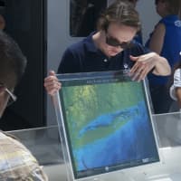 <p>A cruise instructor shows a map of Long Island Sound.</p>