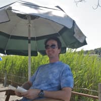 <p>Keeping cool under an umbrella in Westport.</p>