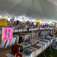<p>Books, books and more books in the big tent at the Westport Library.</p>