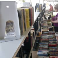 <p>Shoppers look through the rows of books at the Westport Library.</p>