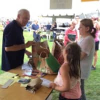 <p>Sunrise Rotarian Nick Clarke tallying books for a happy bibliophile at the book sale. </p>