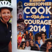<p>Alexis Harrison, a rider for Team SHU, stands by a poster prior to last year&#x27;s ride.</p>