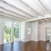 <p>Gorgeous floor length windows bring in lots of light at the home.</p>