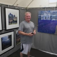 <p>Westport photographer Ron Lake stands with some of his work at the fine art sale.</p>