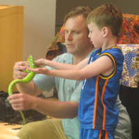 <p>Animal experts show off some garden snakes to young children.</p>
