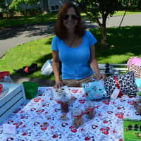 <p>A vendor shows off her wares at the Ridgefield Farmers Market, </p>