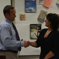 <p>Edward Reder shakes hands with Carole LaColla following the oath of office for school board vice president.</p>