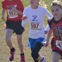 <p>Angela Saidman of the Wilton Running Club runs to a second-place finish in the Midget Girls division.</p>