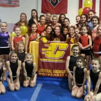 <p>Caroline Fitzpatrick of New Canaan is flanked by her teammates at Stamford&#x27;s Arena Gymnastics as she officially commits to Central Michigan.</p>