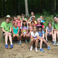 <p>Girls enjoy a temperate summer day at Camp Aspetuck on Wednesday. The counselors  Strudel and Lucky  are in their green staff T-shirts. The unit is known as Raccoon&#x27;s Rest. </p>