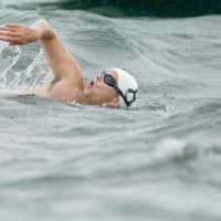 <p>A swimmer powers through the water at the Swim Across The Sound last year.</p>