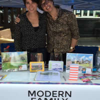 <p>Zinka Benton, left, and Fran Rzeznik hosted a booth for their business, Modern Family Real Estate, at New York City Pride week in June.</p>