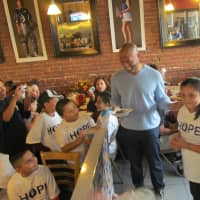 <p>HOPE Community Services client Michelle Oceguera presented cake to Yankees reliever Mariano Rivera in honor of his birthday on Nov. 29.</p>