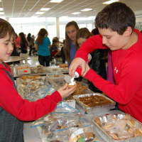 <p>Brent Perlman (left) and Alex Shapiro, students at Armonk&#x27;s H.C. Crittenden school, work during the bake sale.</p>