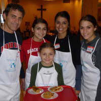 <p>Sisters Gina (front), Emma (second from left) and Paulina (far right) help their parents serve Thanksgiving meals to the hungry Thursday in White Plains.</p>